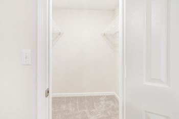 an empty bedroom with white walls and a white door at The Oliver Apartment Homes, Mississippi, 38654